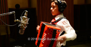 Davis Bilingual Elementary School fourth grader Andres Bentacourt prepares to lay down the accordion track on This Land is Your Land.