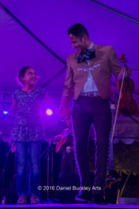 Mariachi Cobre's Joe Baca invites a fan to dance with him.