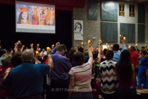 Candles held up at a memorial service for Victoria Arias.