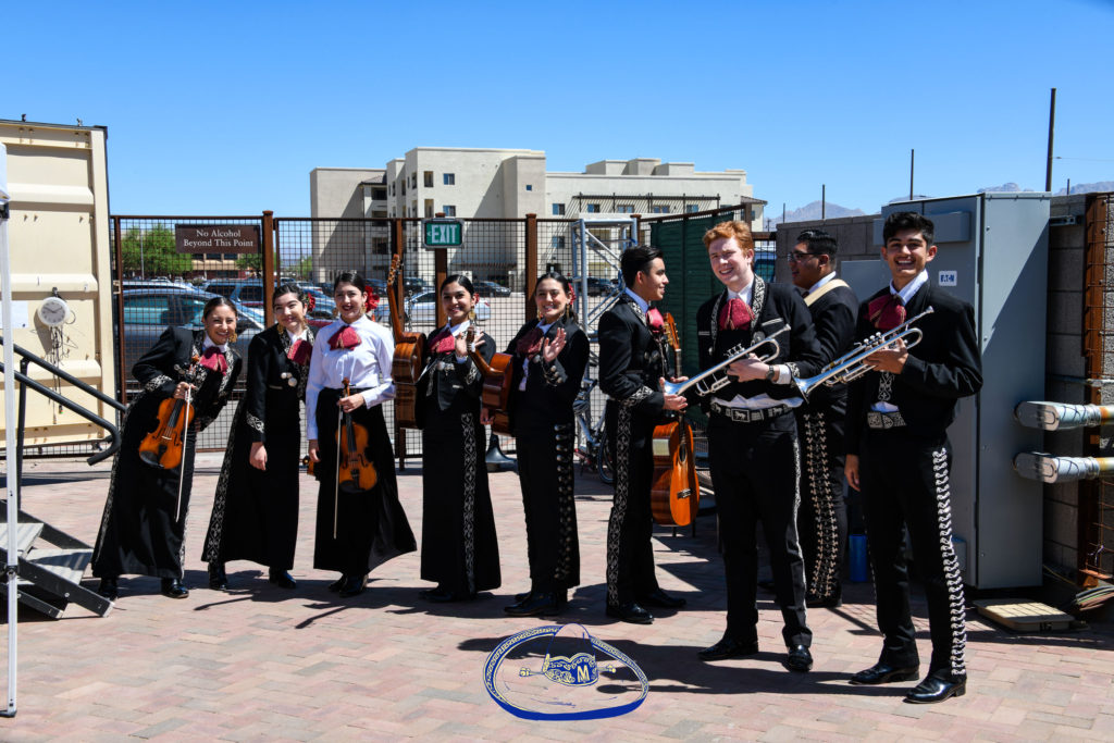 Members of the 2021 crop of the youth mariachi that started it all -Tucson's Los Changuitos Feos – gather by he side of the stage.