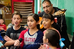 Instructor Jaime Valenzuela prepares a group of students to perform the national anthem at a community function.